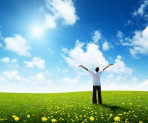 field of grass and happy young man